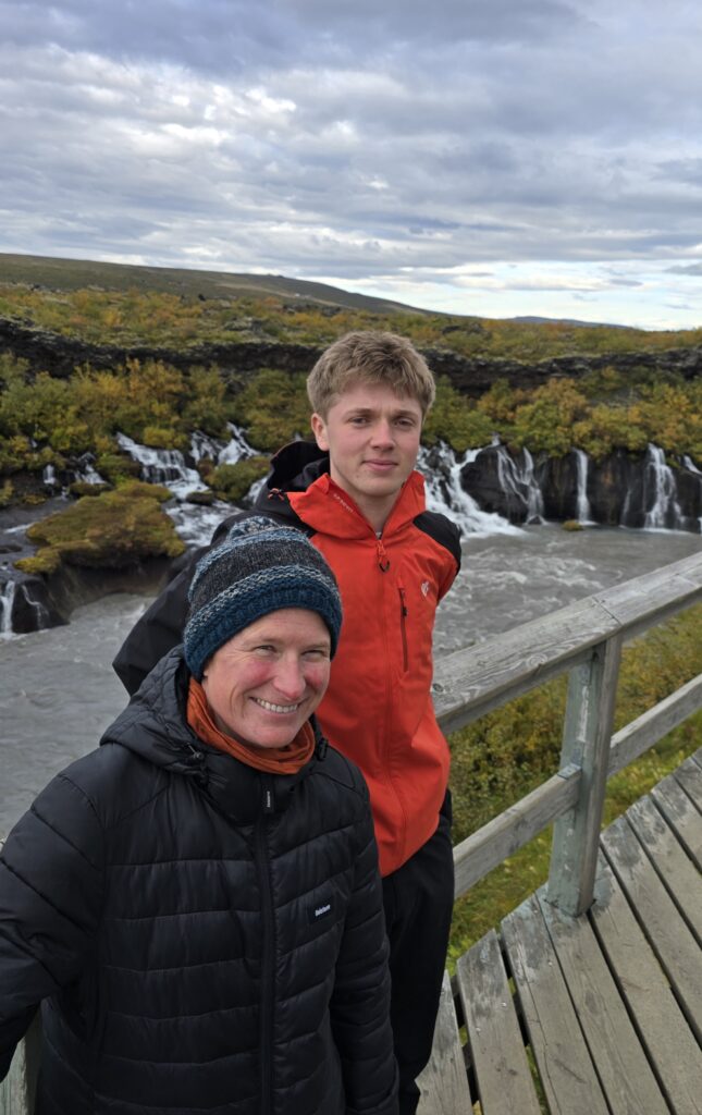 An image of my son and Vic at Hraunfossar, stood on a viewing platform with the river and some cascading water behind