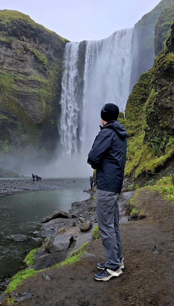 My son facing and looking at Skogafoss. A really high and powerful waterfall on the south coast