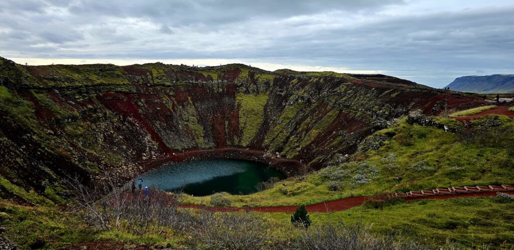 An image of the Kerrid Crater - red and green sides and blue/ green water.
